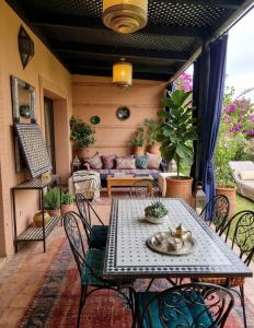 a patio with a table and chairs and a couch at atlas golf resort in Marrakesh