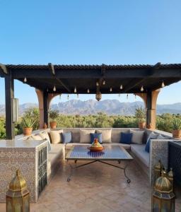 a patio with a couch and a table at atlas golf resort in Marrakesh