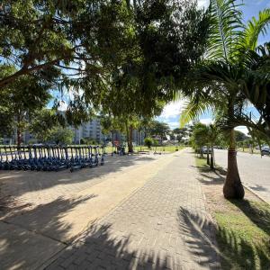 a park with benches and trees on a sidewalk at Apartamento centro de Paulista-Pe in Paulista