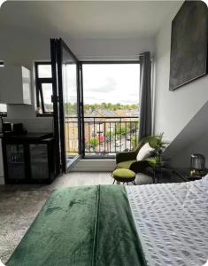 a bedroom with a bed and a view of a balcony at Encliffe apartment in Nether Edge +1 photo