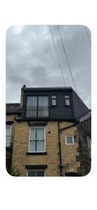 a building with a balcony on top of it at Encliffe apartment in Nether Edge