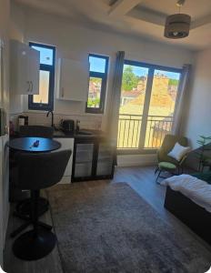 a kitchen and living room with a table and chairs at Encliffe apartment in Nether Edge