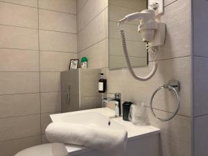 a bathroom with a sink and a shower at Oliva Apartman in Bük +32 photos