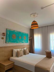 a bedroom with a large bed with a blue wall at Bodrum Merkez Pansiyon in Bodrum City