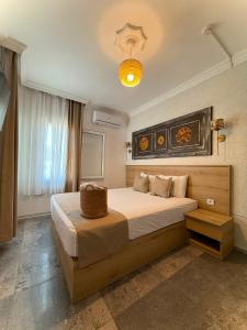 a bedroom with a large bed in a room at Bodrum Merkez Pansiyon in Bodrum City