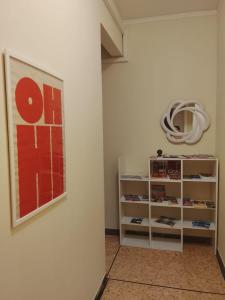 a room with a painting on the wall and a shelf at KALEIDO Hostel in Genoa