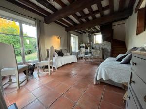 a bedroom with two beds and a table and chairs at Le Colombier de Hanches - Teritoria in Hanches