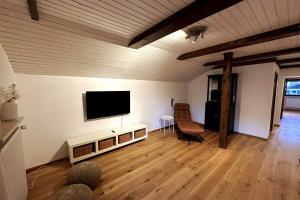 a living room with a flat screen tv on a wall at Apartment in the Upper Bavarian Alps in Bad Kohlgrub