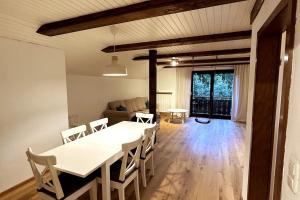 a dining room and living room with a table and chairs at Apartment in the Upper Bavarian Alps in Bad Kohlgrub