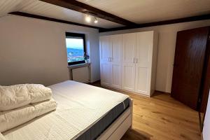 a large bedroom with a bed and a window at Apartment in the Upper Bavarian Alps in Bad Kohlgrub