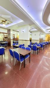 a conference room with blue chairs and a wooden table at Sama Al Bayt in Mecca +31 photos