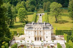 a large white building with a tower on top of it at Apartment in the Upper Bavarian Alps in Bad Kohlgrub