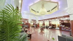 a lobby with a palm tree in the middle of a building at Sama Al Bayt in Mecca