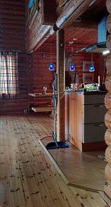 a room with a kitchen and a bar in a building at Kuulapää Chalet in Äkäslompolo