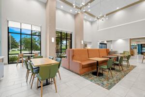 a lobby with tables and chairs and a couch at Hampton Inn and Suites Swansboro Near Camp Lejeune in Swansboro