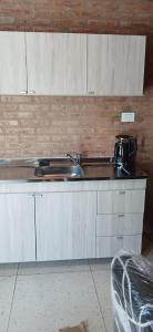 a kitchen with a sink and a counter top at lo de la Gri in El Volcán