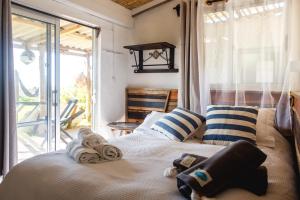 a bedroom with a bed with towels on it at Carmela Suites Cabo Polonio in Cabo Polonio