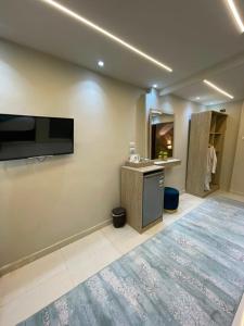 a bathroom with a tv on the wall and a counter at Gaillon Scarab Pyramids View in Cairo