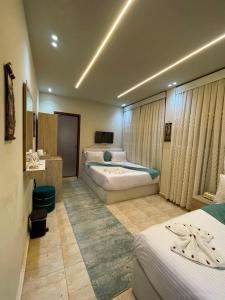 a hotel room with three beds in a room at Gaillon Scarab Pyramids View in Cairo