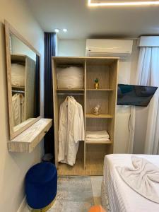 a bedroom with a closet with a mirror and a bed at Gaillon Scarab Pyramids View in Cairo