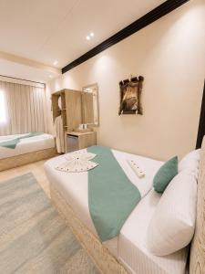 a bedroom with a large bed in a room at Gaillon Scarab Pyramids View in Cairo +21 photos