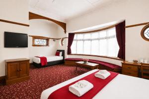 a hotel room with two beds and a tv at Halswell Lodge in Wellington