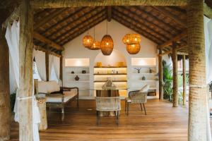 a living room with a table and chairs at Yemanjá Hotel by Preabeach Experience in Prea