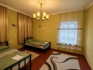 a bedroom with two beds and a window at GreenHouse in Qusar