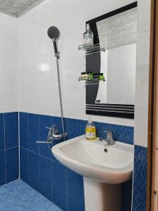 a bathroom with a sink and a mirror at GreenHouse in Qusar