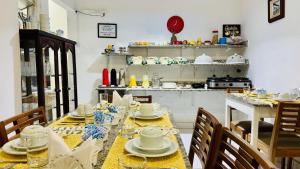 a dining room with a table with dishes on it at Pousada Jara in Conservatória