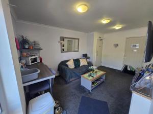 a living room with a couch and a table at Haybow Farm Accommodation in Rolstone