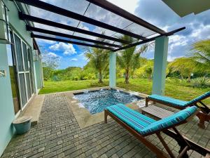 a patio with a bench and a swimming pool at Bliss Resort in San Juan del Sur