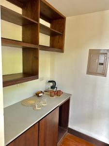 a kitchen with a counter with glasses on it at Bliss Resort in San Juan del Sur