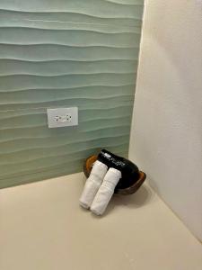 a pair of towels in a basket in the corner of a room at Bliss Resort in San Juan del Sur