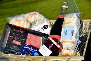 a basket filled with food and bottles of wine at No 15 Lomond Castle in Balloch +14 photos