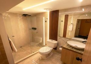 a bathroom with a toilet and a sink and a shower at Hotel Biba Life - Chia in Chía
