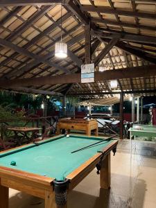 a pool table in the middle of a room at Pousada Ilha do Meio in Itacimirim