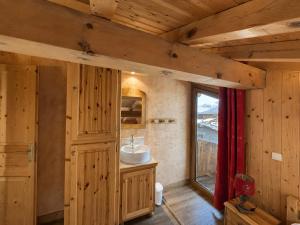 a bathroom with a sink and a mirror and a window at Le Tyrol in La Plagne Tarentaise +14 photos