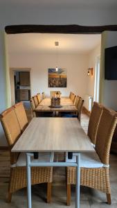 a dining room with a wooden table and chairs at Ferienhaus Weserblick in Rinteln