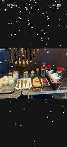 a table topped with different types of food on at Nogai Karavan in Türkistan
