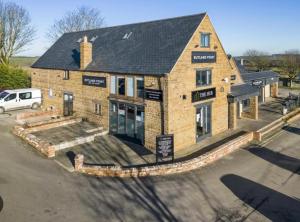 a building with a car parked in front of it at Rutland Point in Uppingham