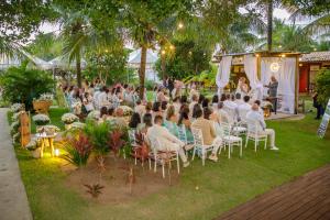 a group of people sitting in chairs at a party at Pousada Ilha do Meio in Itacimirim +75 photos