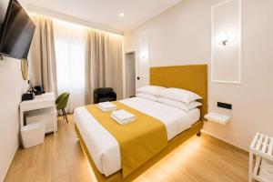 a hotel room with a large bed and a television at Ciao Termini in Rome