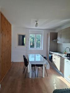 a kitchen with a table and chairs in a room at Aux Ogiers in Croix +13 photos