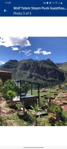 a picture of a mountain with palm trees at Wolf Totem Steam Punk Guesthouse in Pisac