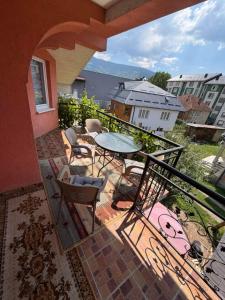 a patio with a table and chairs on a balcony at Dino's Apartments in Plav