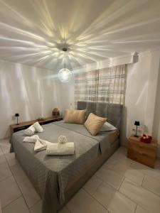a bedroom with a large bed with towels on it at Panora House in Kefalos