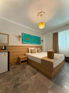 a bedroom with a large bed in a room at Bodrum Merkez Pansiyon in Bodrum City