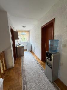 a kitchen with a stove with a container on top of it at Dino's Apartments in Plav