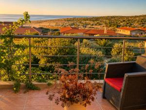 a balcony with a chair and a view of the ocean at chalet de paradis in Bizerte +12 photos